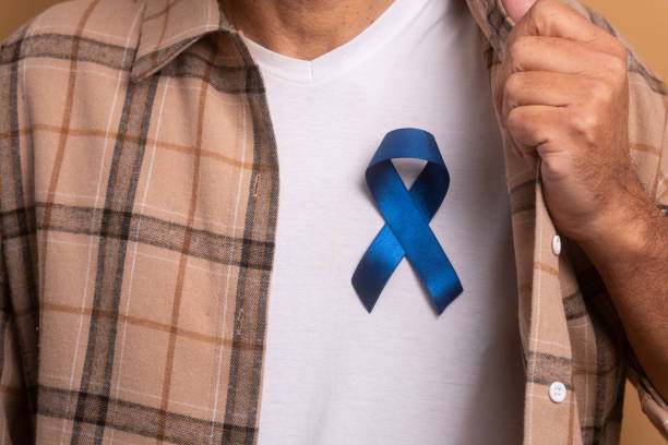 istock man showing blue ribbon 1583202298