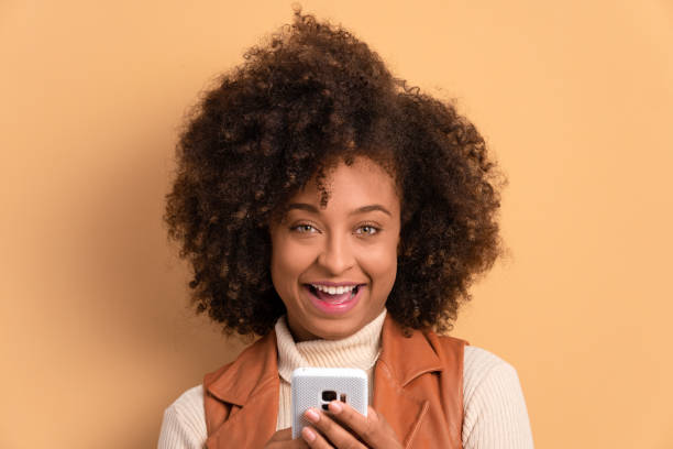 istock joyful woman watching video and photos on mobile 1583207923