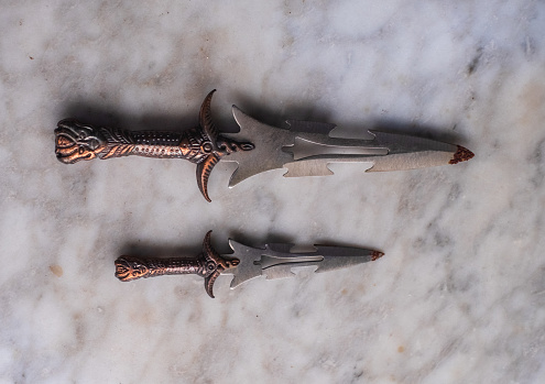 Two United Cutlery Isis Dagger made based on Egyptian fantasy are isolated in white background