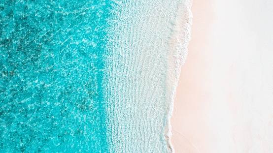 Top Down Aerial Drone Image of Shoreline in Maldives. Bright Blue Crystal Clear Water and White Sandy beach. beautiful paradise tropical island. Summer and travel vacation