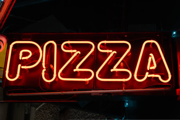 istock neon sign with pizza word 1583282335