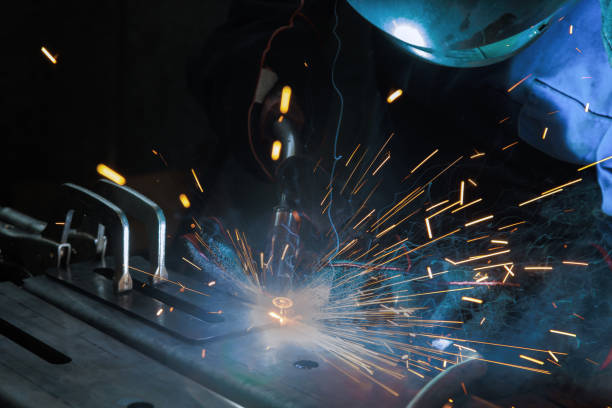 istock This workplace where a worker is welding steel at work a spark lighting smoke in a factory 1583306008