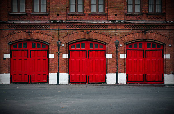 Fire Station with red doors Facade of an old Fire Station with red doors.. fire station stock pictures, royalty-free photos & images