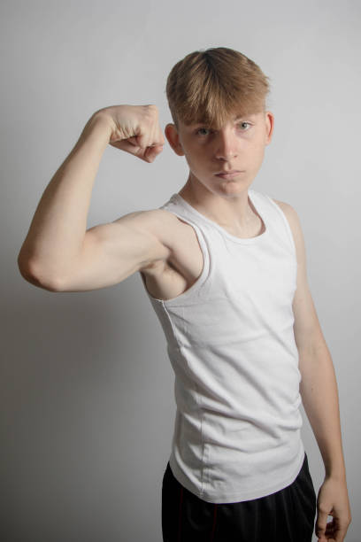 istock Teenage boy flexing his bicep 1583328064