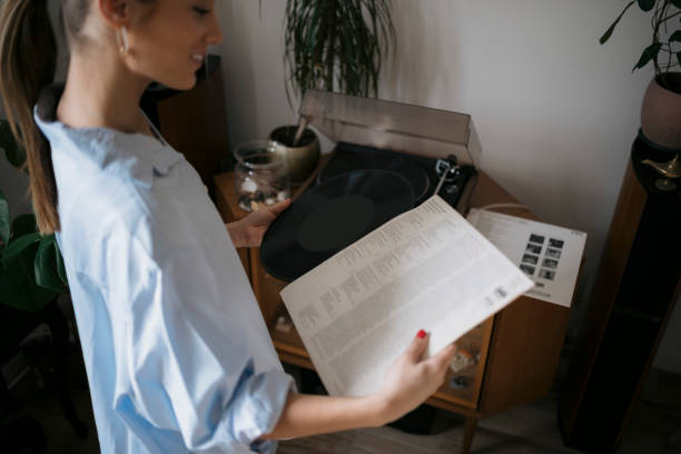 istock Young female holding vinyl music disc at home 1583328596