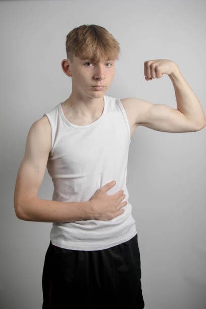istock Teenage boy flexing his bicep 1583330224