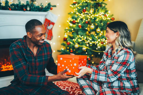 istock Young couple celebrating Christmas at home 1583350473