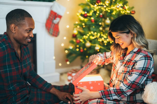 istock Young couple celebrating Christmas at home 1583352144