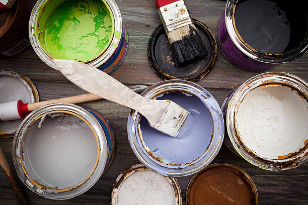 istock A bunch of open paint cans with brushes 158335687