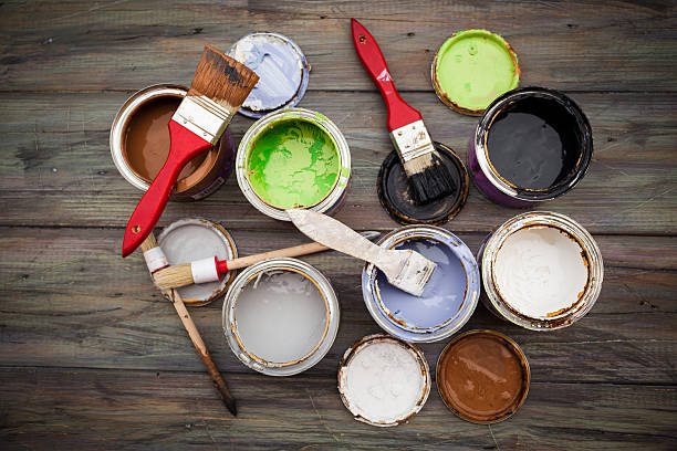 istock Various paint cans of different colors and paintbrushes 158335712