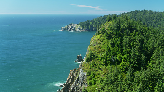Aerial view of the Pacific Ocean crashing against the cliffs of the Oregon Coast at Neahkahnie Lookout.