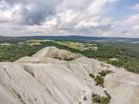 Aerial view of mountain rock residue from Black Lake quarry during summer day