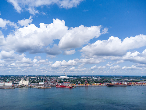 Aerial view of Montreal Olympic stadium and St. Lawrence river from South Shore during summer day