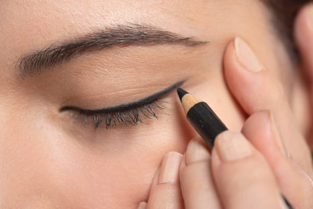 istock woman applying cosmetic pencil on eye 1583389226