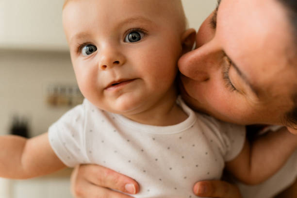 istock Mother kissing her baby boy 1583400566