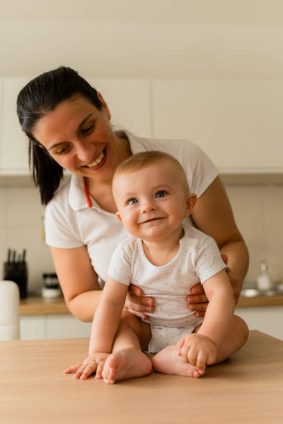 istock Mother and baby smiling in the kitchen 1583400583