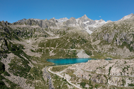 aerial view of cornisello lake surrounded by mountains in trentino