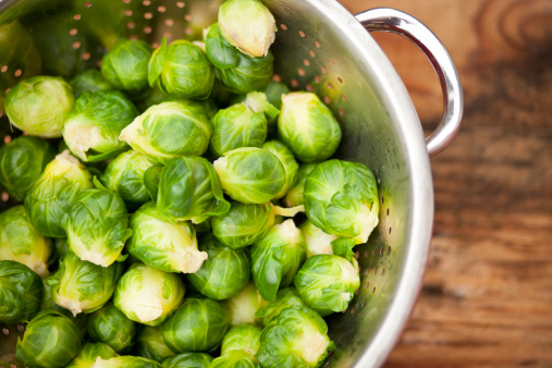 Uncooked brussels sprouts in a colander