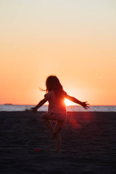 istock Little girl at the beach 1583435483