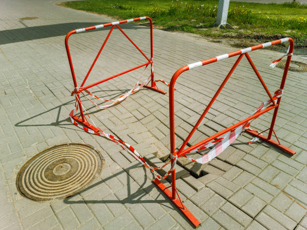istock Fence in front of a sinkhole in the sidewalk 1583436024
