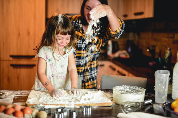istock cheerful family in a kitchen having fun. 1583445883
