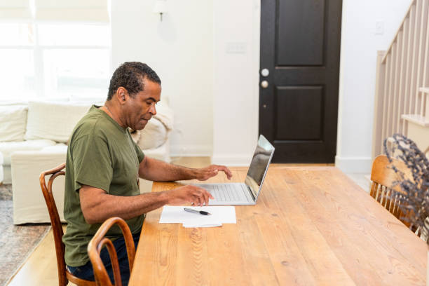 istock Senior man works from home using laptop 1583459379