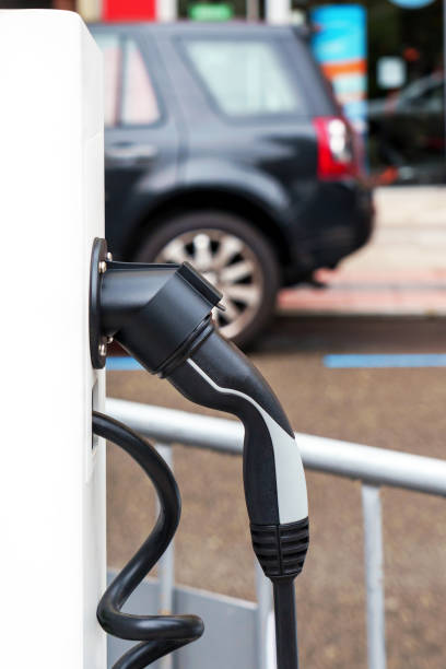 istock Electric car charging station with plug closeup. Power supply point 1583460970
