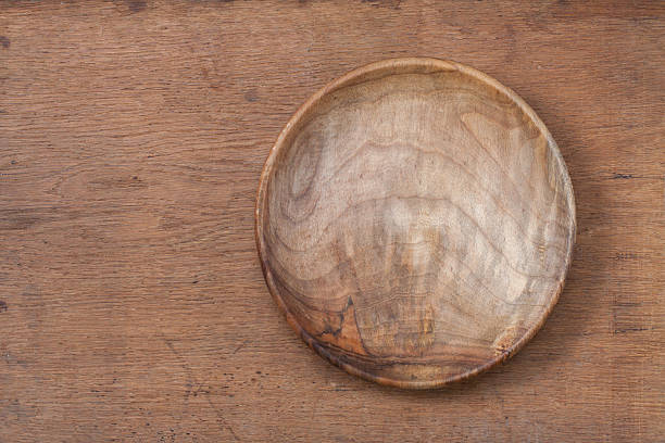 istock Vintage empty wooden plate on oak table wood texture background 158346441
