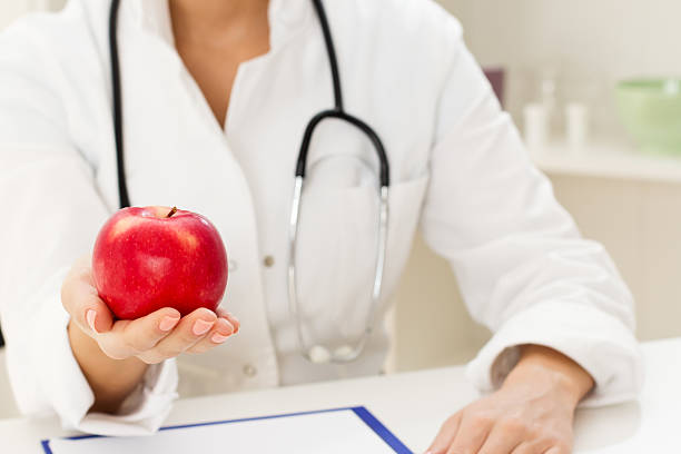 istock Apple in a female doctor's hand 158347059