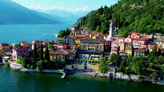 Aerial 4K footage of Varenna old town, Como Lake. Aerial panoramic of town surrounded by mountains