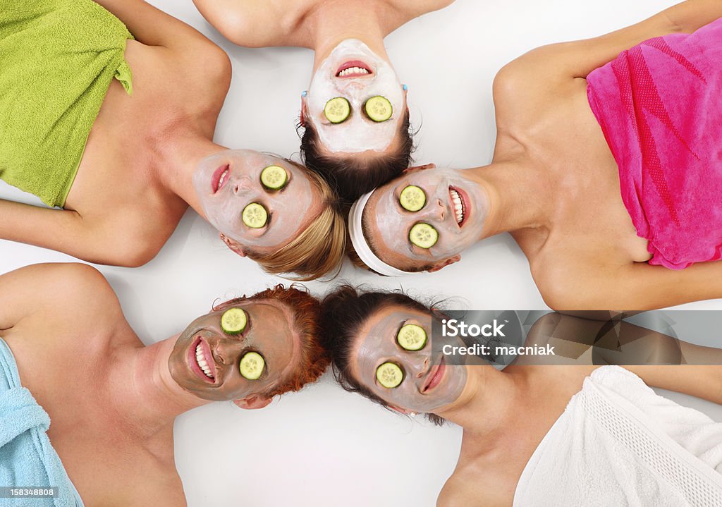 Facial masks A picture of five girl friends relaxing with facial masks on over white background Group Of People Stock Photo