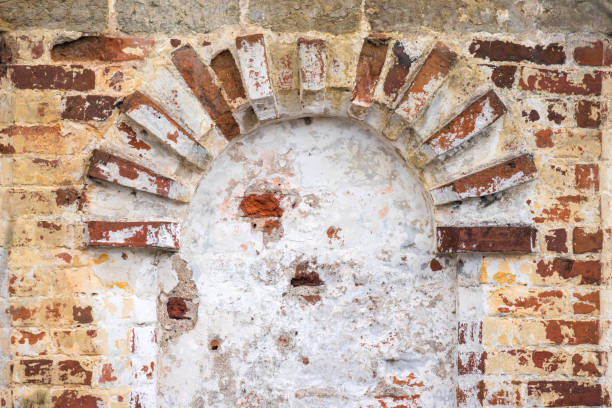 istock Old brick wall with white arch, ancient Orthodox church 1583499556