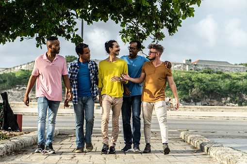 Group of young friends walking and talking outdoors