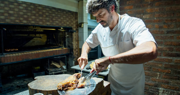 istock Argentinian Parrilla Chef Slicing Meat 1583501702