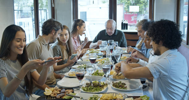 istock Large Family Having Meal Together Inside Argentinian Restaurant 1583502417
