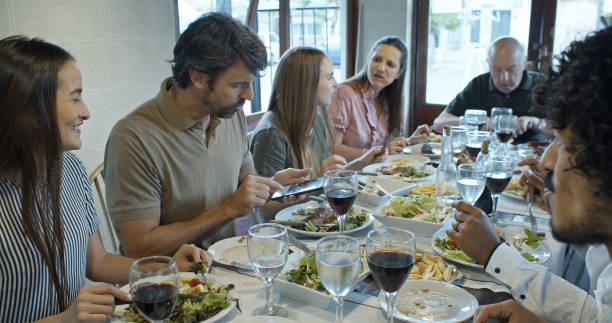 istock Large Diverse Family Enjoying Meal in a Rustic Parilla Restaurant 1583502799