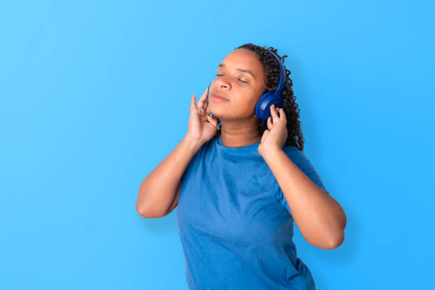 istock Black woman  with wireless headphones 1583503197