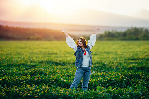 Woman with open up arms to sun. Hands up. Free girl, amazing summer adventure, countryside, rural scene. High quality