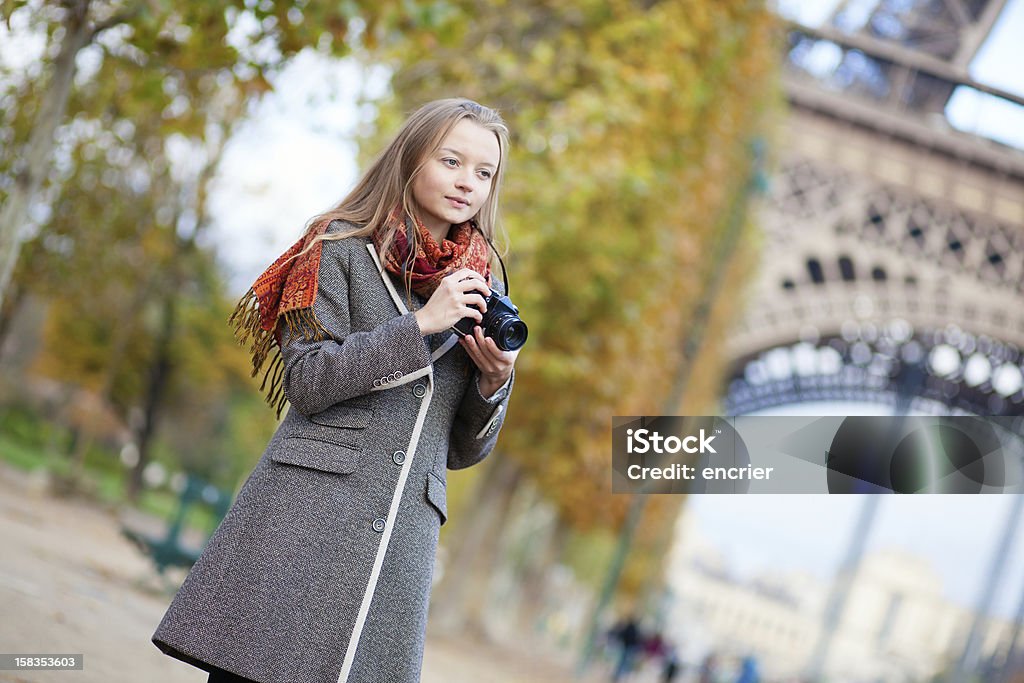 Beautiful girl with photo camera Beautiful girl with photo camera near the Eiffel tower in Paris Adult Stock Photo