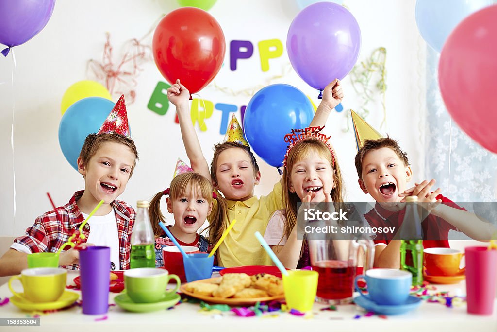 Birthday party Group of adorable kids having fun at birthday party Child Stock Photo