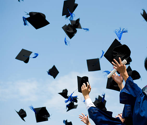 graduation high school graduation hats high graduation throwing cap stock pictures, royalty-free photos & images