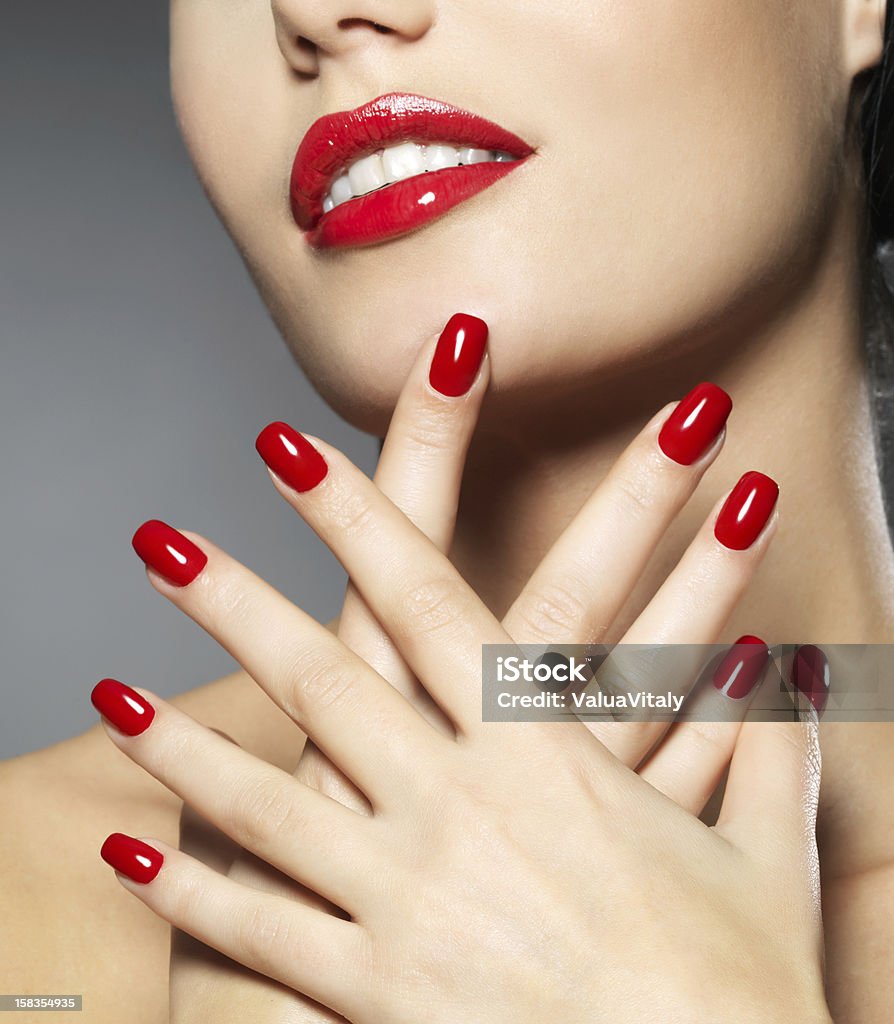 woman with fashion red nails and sensual lips Young woman with fashion red nails and sensual lips - Model posing in studio Manicure Stock Photo