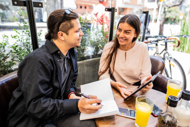 istock Happy coworkers working at a coffee shop 1583575486