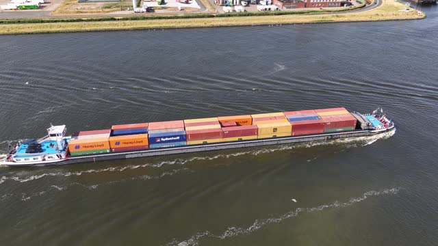 Amsterdam, 21st of June 2023, The Netherlands. Inland shipping container ship top down view.