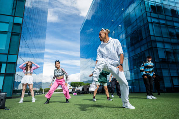 istock Dance teacher teaching his students outdoors 1583586675