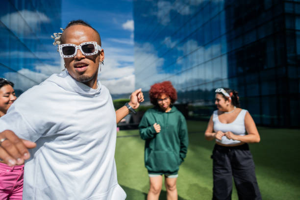 istock Young man dancing with his friends outdoors 1583587193