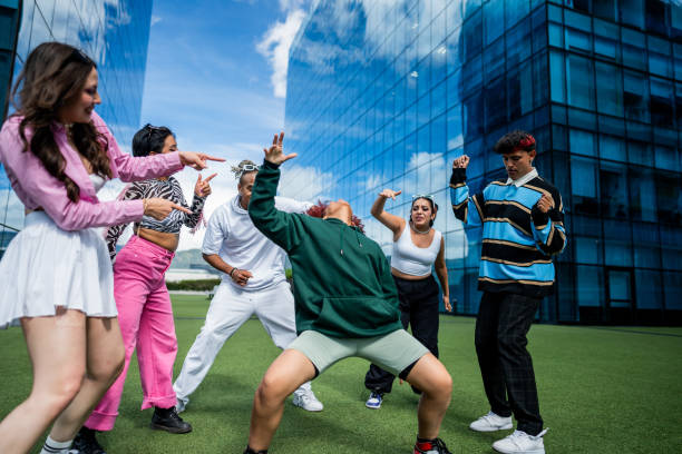 istock Group of young dancers dancing outdoors 1583588271
