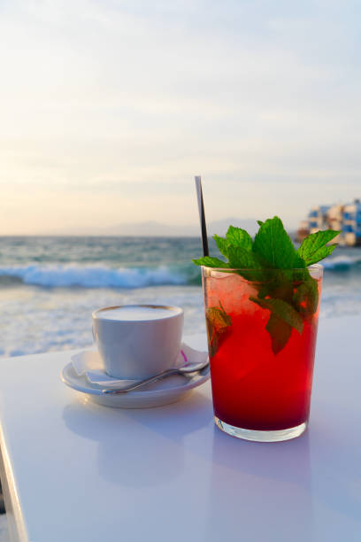 seaside cafe at Mykonos island with cafe and mojito drink, Greece at summer