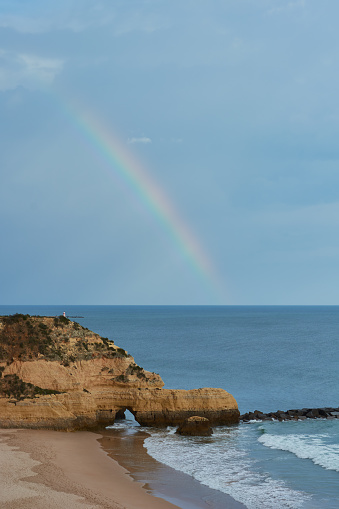 Rainbow over the Atlantic Ocean. Praia dos Tres Castelos in Portimao, Algarve, Portugal