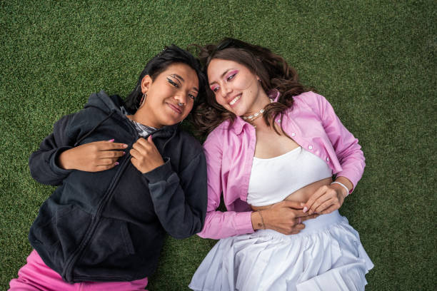 Female friends lying down outdoors